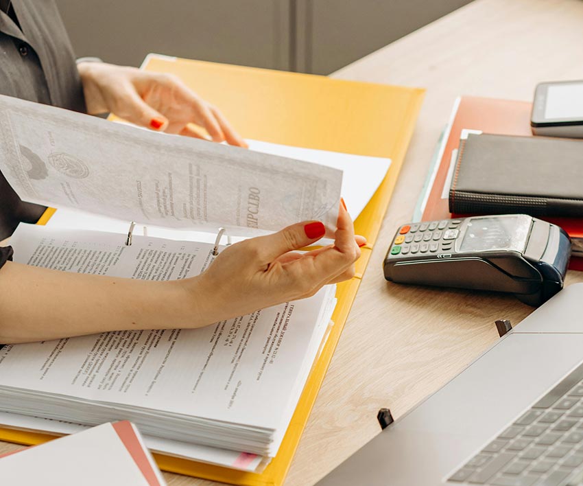 accountant reviewing paperwork for payroll services Maurice LA